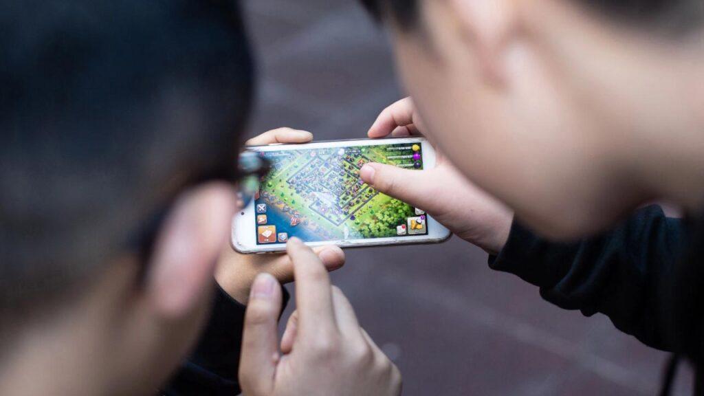 Two people playing mobile game on a phone