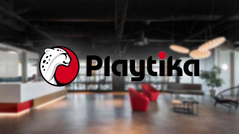 Playtika Games logo on a blurry office background