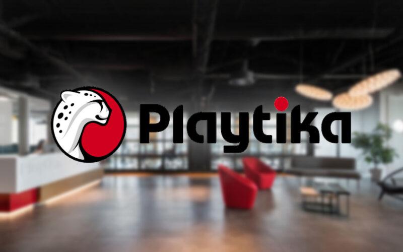 Playtika Games logo on a blurry office background