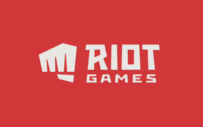 Riot Games logo on a brick red color background