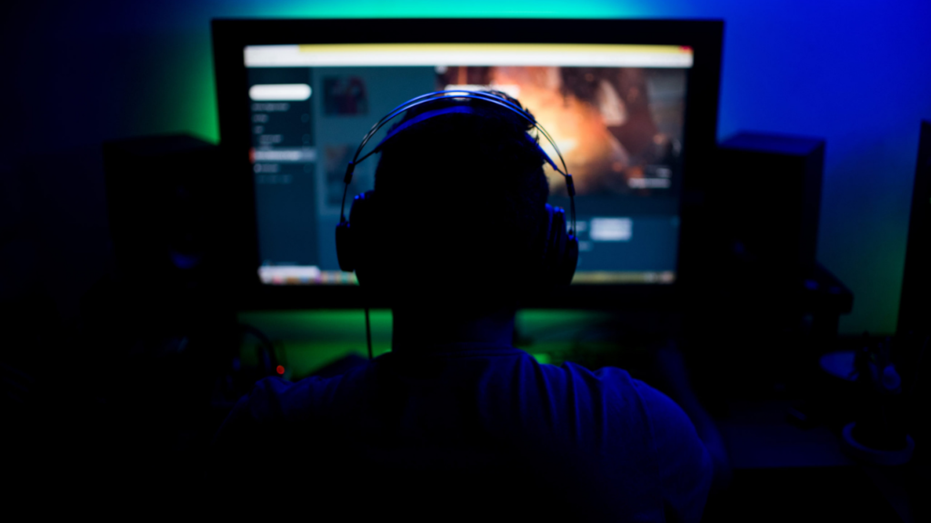 An adult male is playing games with his headphones