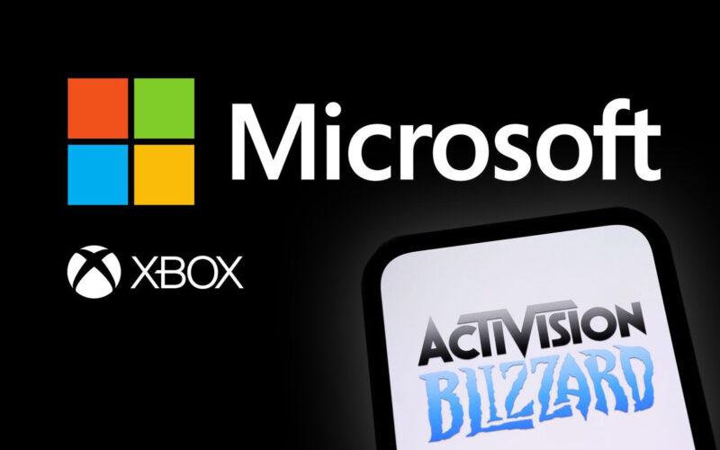 Microsoft and Xbox logos on a black background, while a phone with Activision Blizzard logo is being held