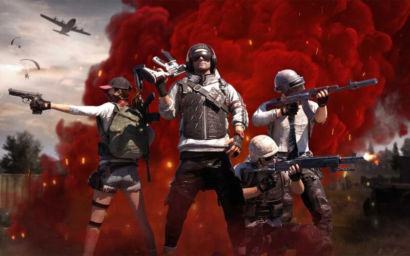 PUBG players shooting at targets off camera with a red smoke screen behind them