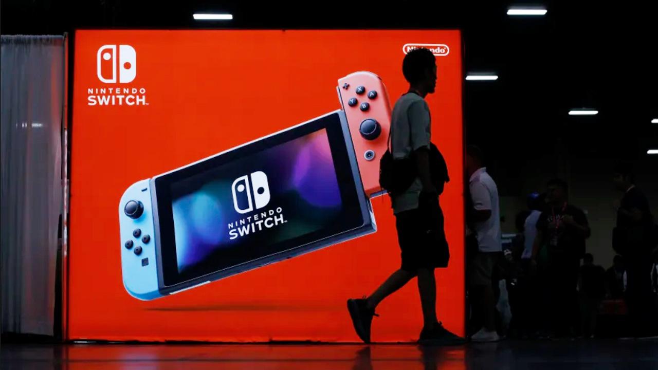 A guy in front of Nintendo Switch ad