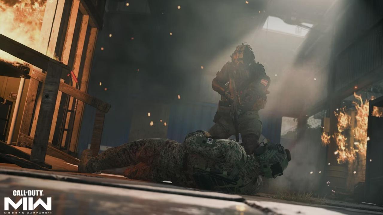 A soldier trying to help out another soldier out from a burning warehouse