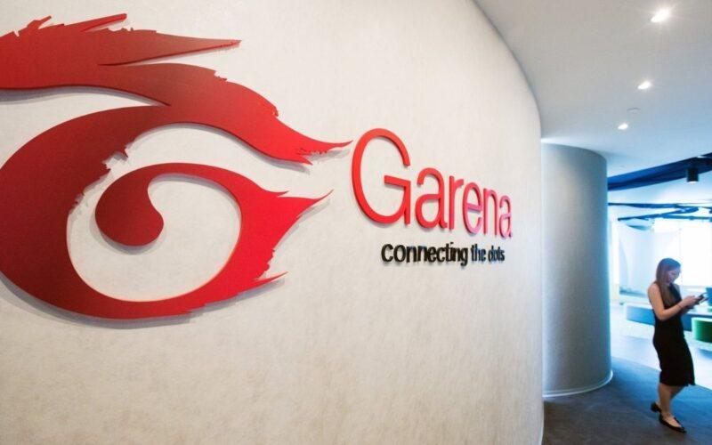 A walking woman and Garena logo on a white wall