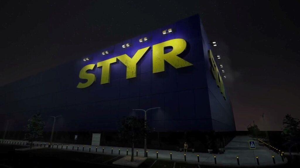 A blue, box-like building with STYR written on it with yellow letters