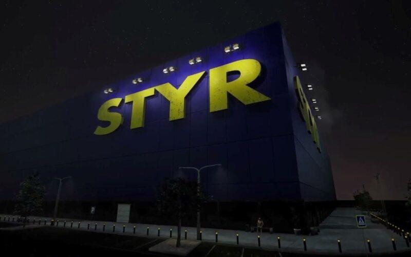 A blue, box-like building with STYR written on it with yellow letters