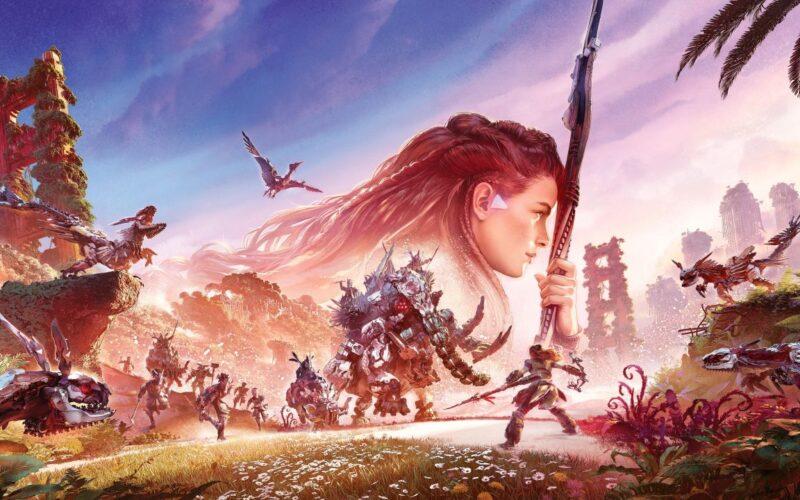 Aloy holds her bow vertically before her in the background. Several enemies from Horizon: forbidden west are showcased in a beutiful field of flowers