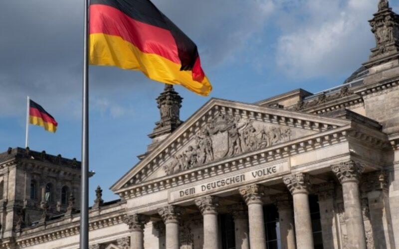 The German parliament building, and the German flag