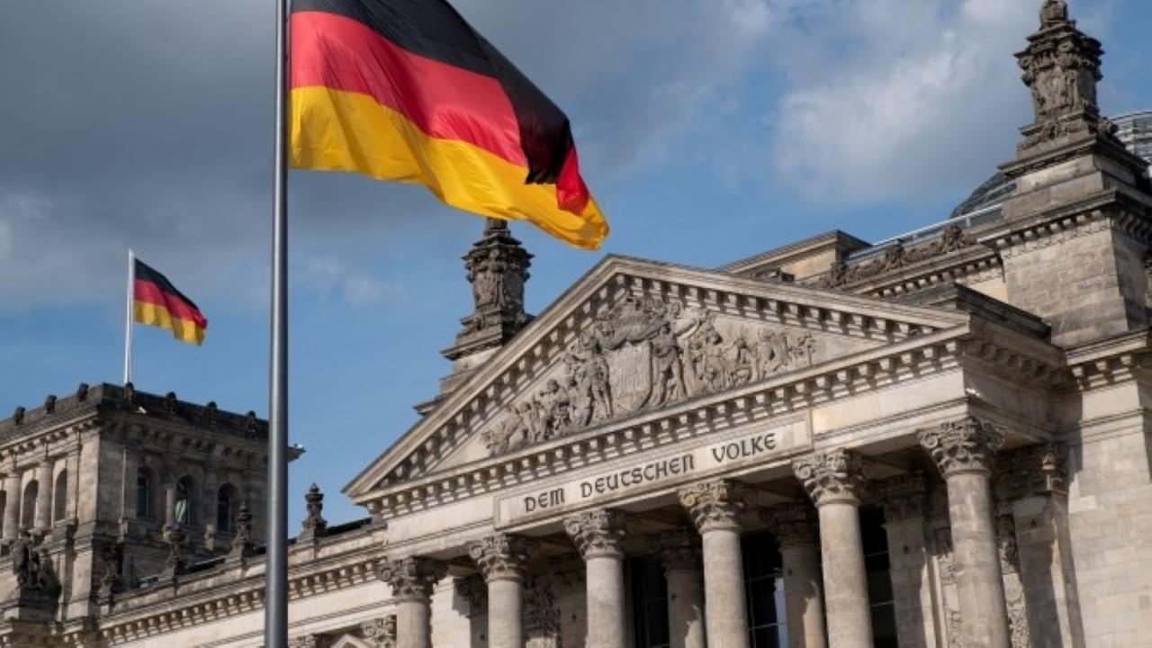 The German parliament building, and the German flag