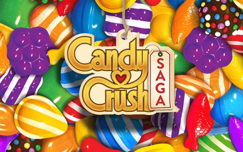 Candy Crush logo, with a backdrop of a lot of candies.