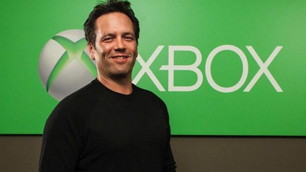 phil spencer xbox boss standing in front of xbox logo