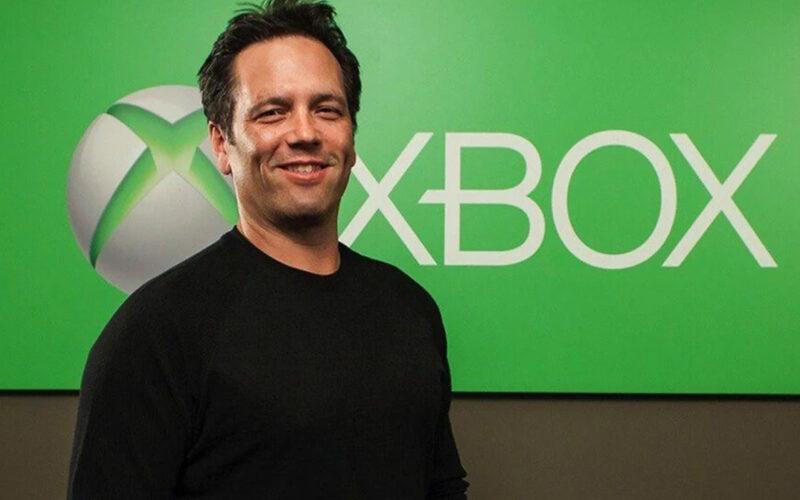 phil spencer xbox boss standing in front of xbox logo