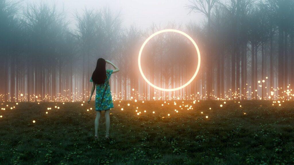 A girl looking towards a forest illuminated with bright dots of light. A circle of light floating in the ait in front of her
