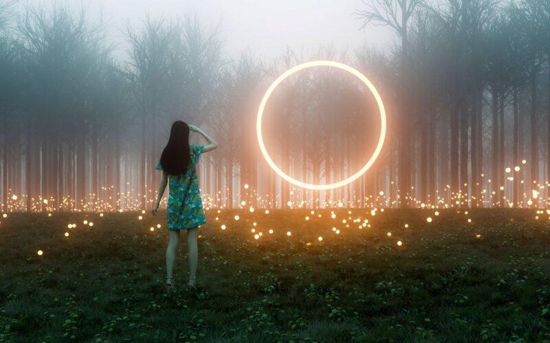 A girl looking towards a forest illuminated with bright dots of light. A circle of light floating in the ait in front of her
