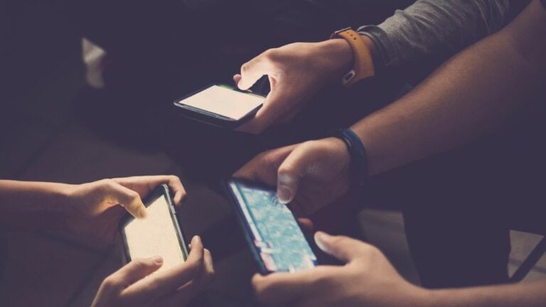 various people playing hyper-casual games on mobile devices.