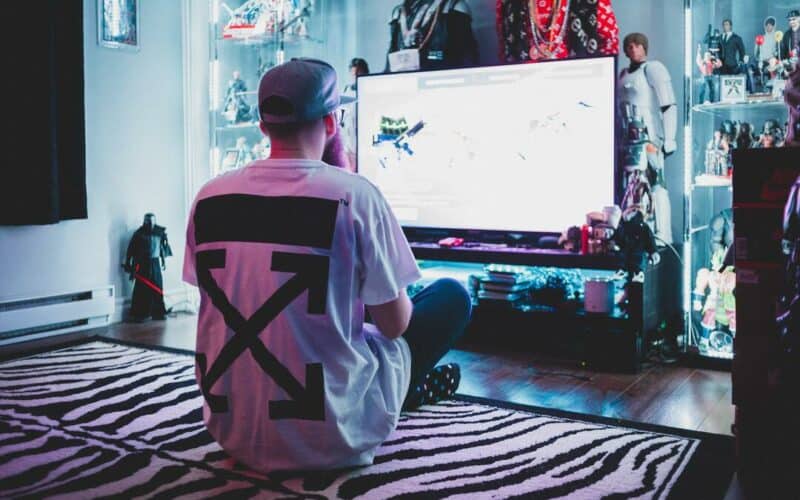 male adult playing games on smart tv