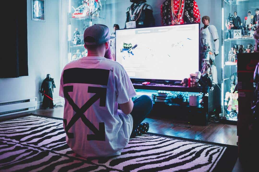 male adult playing games on smart tv