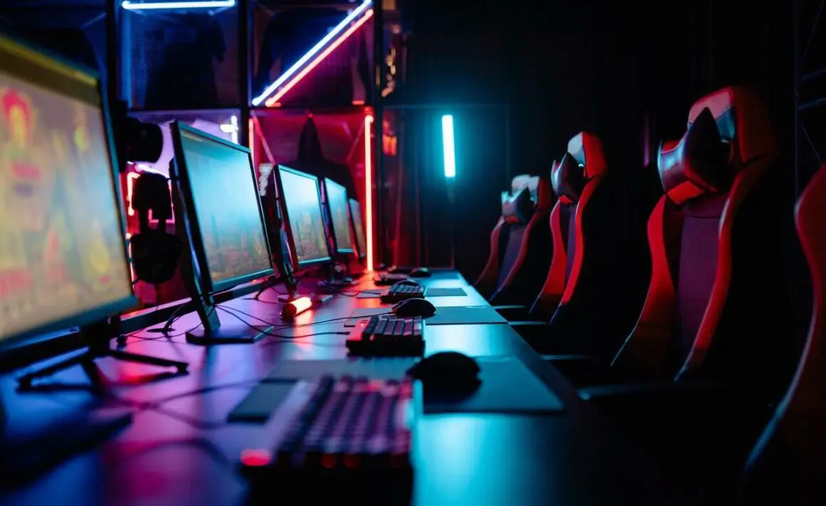 computers with games on their screen and empty chairs
