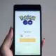 phone with the game pokemon go on the screen