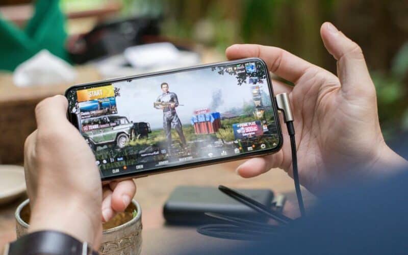 man playing a mobile game on phone
