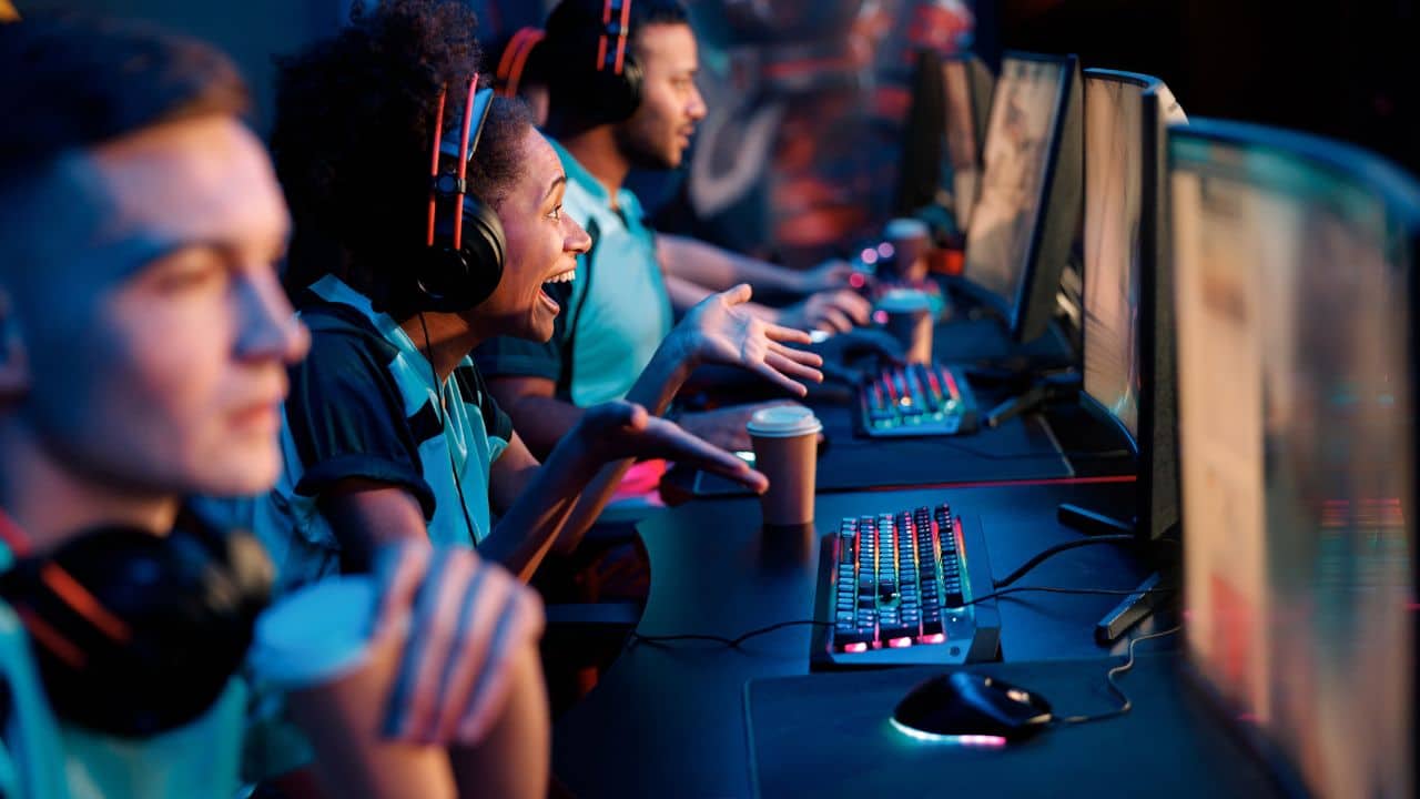 cover image for the article, "How to build an engaged game community beyond Twitter (X)" featuring various gamers together in front of PCs.