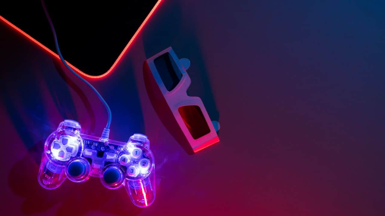 game controller and 3d glasses on a dimly lit desk.