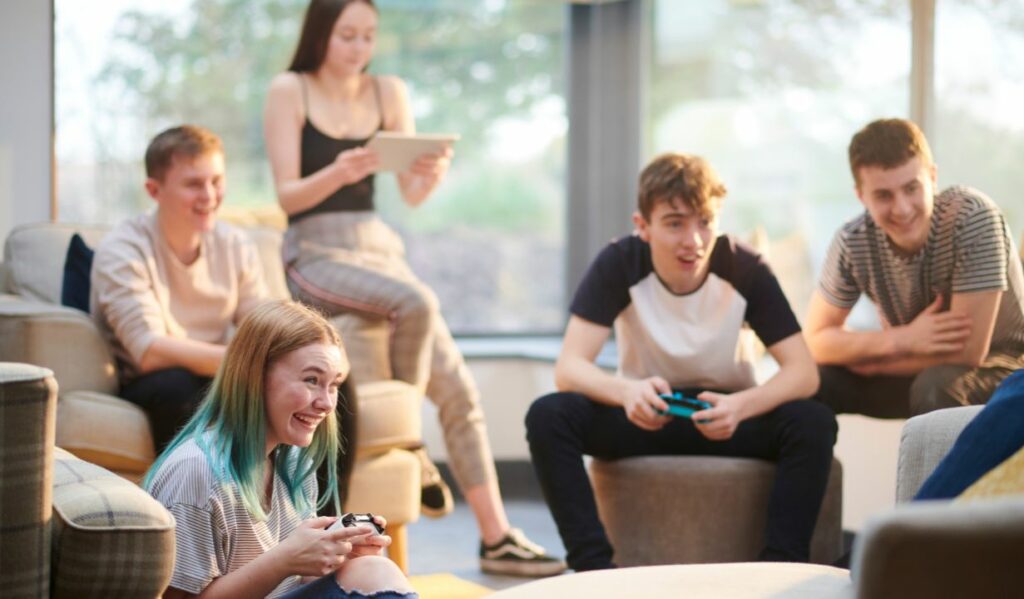 group of young people playing video games.