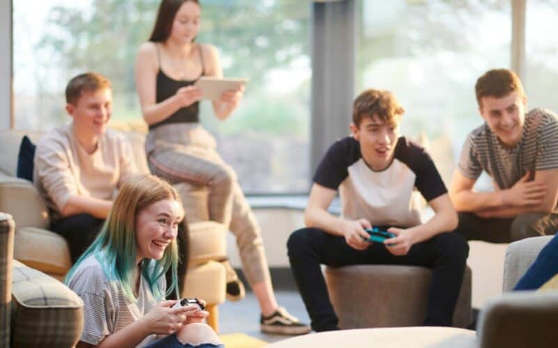 group of young people playing video games.