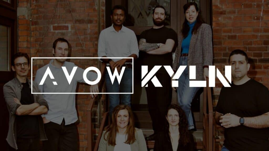 awol and kyln employees posing in front of a brick building, celebrating their new found business.