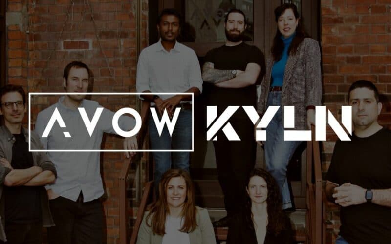 awol and kyln employees posing in front of a brick building, celebrating their new found business.