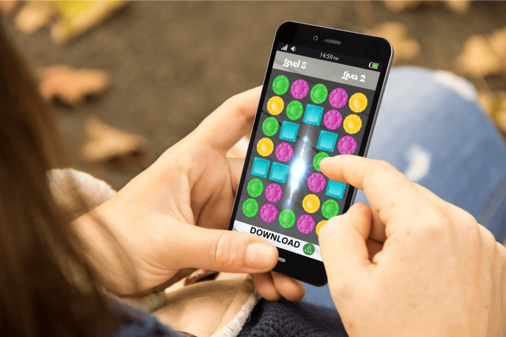 playable ads image showing a woman playing a game on her phone with a download button below, indicating she is actually playing an add