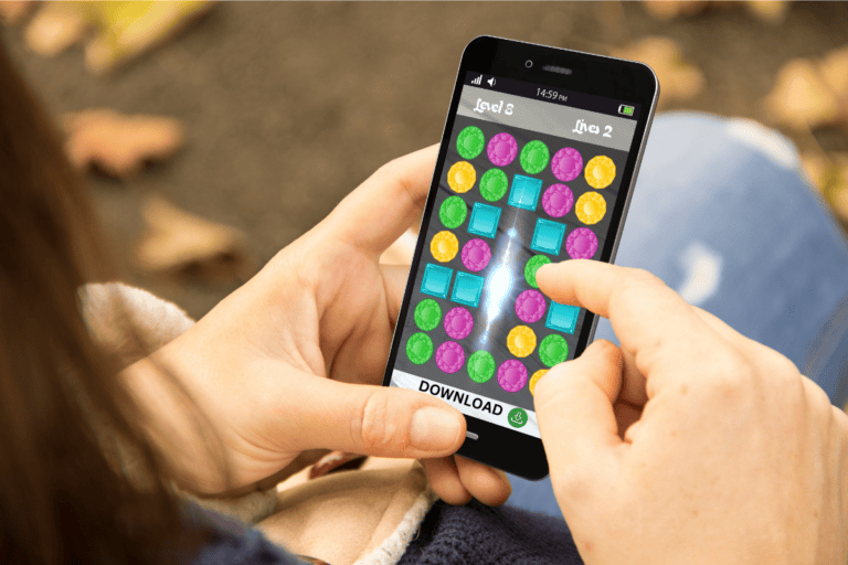 playable ads image showing a woman playing a game on her phone with a download button below, indicating she is actually playing an add