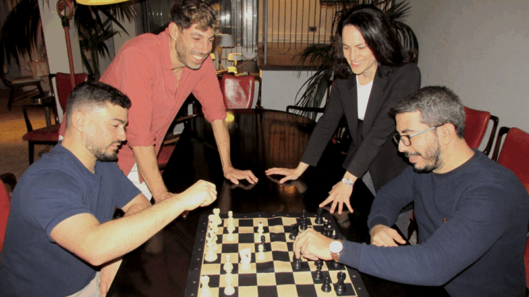 Zoe Studios team photo where they play chess (2 people playing, other 2 watching)